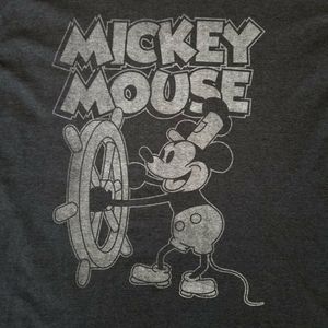 Mickey Mouse as steamboat Willie at the helm of th